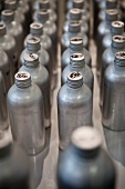 Rows of Metal Bottles with French Writing