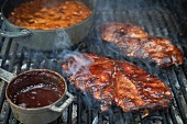 Barbecue Pork Steaks and Baked Beans on a Grill