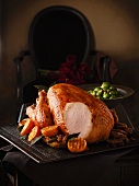 Roast turkey with clementines and Brussels sprouts, partly sliced