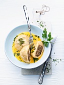 Yeast dumplings with a mushroom filling, in a squash sauce