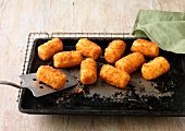 Potato Croquettes on baking tray and wire rack