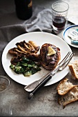 Beef steak with accompaniments, red wine and bread