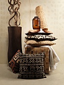 An African feel: cushions in shades of brown and a floor vase holding liana wood