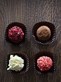 Four different chocolate truffles (view from above)