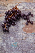 Red grapes on a weathered surface