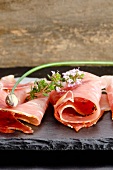 Black Forest ham with herbs on a slate slab