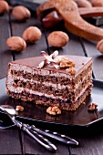 A slice of walnut layer cake with chocolate curl