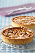 Two almond tarts on a cooling rack
