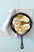 Poached fish steaks in onion and white wine sauce
