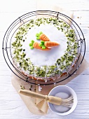 Carrot cake with sugar icing and pistachios