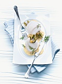 Plaice fillets wrapped around pickled gherkins, with a dill sauce