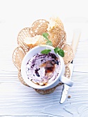 Creamy blueberry spread and a chunk of sesame bagel in a bread basket