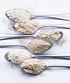 Assorted types of flour on teaspoons