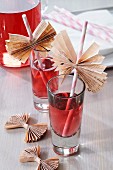 Straws decorated with wings of folded newspaper