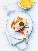 Steamed fillet of wels catfish on a bed of carrots with honeydew honey