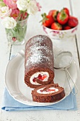 Chocolate roll with strawberries and cream