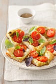 Phyllo dough pizza with cherry tomatoes, mozzarella and basil