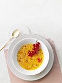 Creme brulee garnished with red currants
