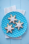 Three gingerbread stars garnished with icing