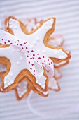 Pile of gingerbread stars garnished with icing and tied with bow
