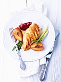 Grilled chicken breast with plums and spring onions