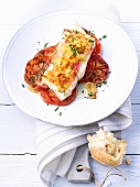 Pollock au gratin with onions and tomatoes