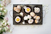 Madeleines and wagashi with roses in an antique baking tray with roses