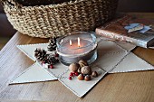 Star made of leather triangles stitched together as festive mat for candle arrangement; woven basket in background