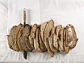 Slices of brown bread made from mixed rye and wheat flour, lined up together