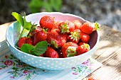 Strawberries in a bowl on a garden table