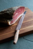 Raw ham with knife and board