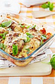 Oven-baked chicken with tomato sauce and basil