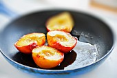 Fried peaches in a pan