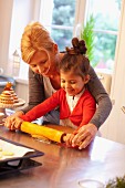 A mother and daughter rolling dough for Lebkuchen (spiced soft gingerbread from Germany)