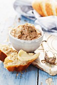 Tuna pâté with white bread on a blue wooden surface