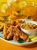 Chicken satay skewers with coconut coating and mango salsa