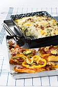 Cauliflower & rice bake and pizza with sliced sausage