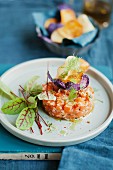 Salmon tartar with fresh herbs and colourful potato chips