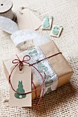Present wrapped in brown paper decorated with tag and Easter stamp motifs