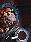 Roast beef with root vegetables and a dark gravy