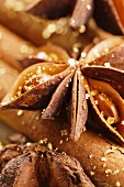 Star anise and cinnamon sticks with gold dust (close-up)