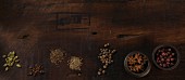 Assorted spices on a wooden surface