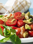Tomato and avocado salad with onions and olive oil