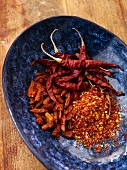 Dried chillies, whole and ground, in a blue dish