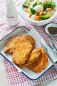Breaded chicken schnitzels with a side of vegetables