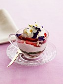 Yoghurt dessert with sliced strawberries and pansies
