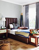 Brown bed with upholstered headboard in elegant, masculine bedroom