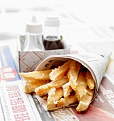 Tempura sweet potato chips wrapped in a japanese newspaper cone
