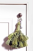 Pom-pom and key on doorknob