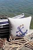 Maritime cushions decorated in classic blue and white with jute yarn and fabric paint
